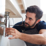 Plumber fixing a faucet