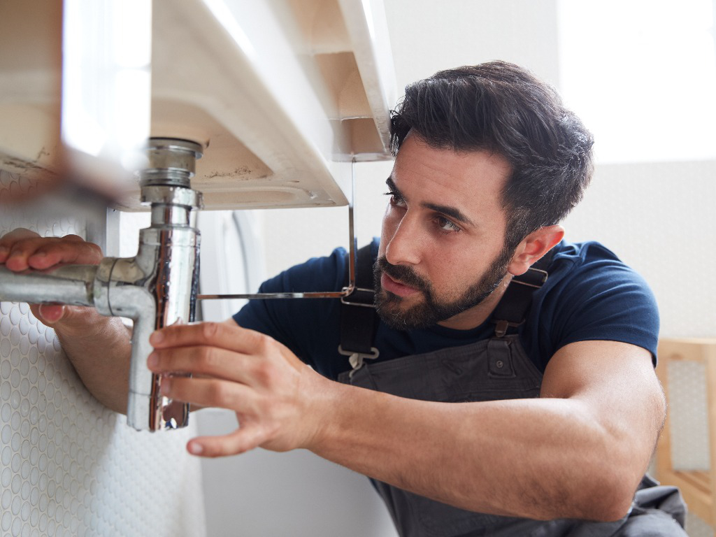 Plumber fixing a faucet