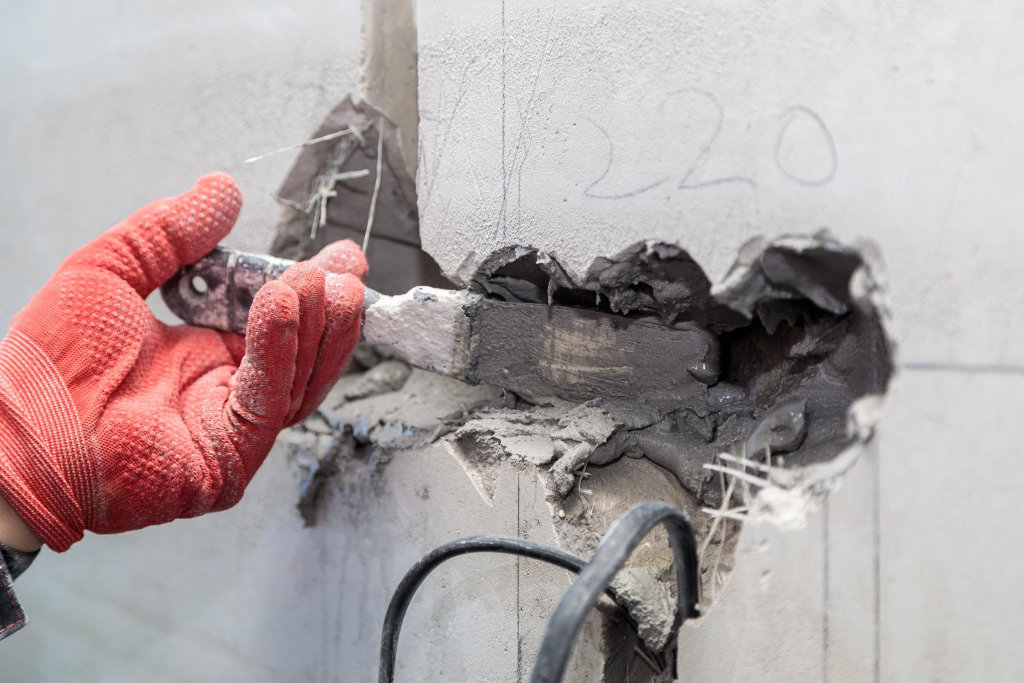 Electricians working on plaster holes and channels