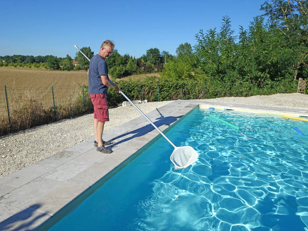 Pool Maintenance man cleaning a pool