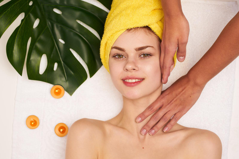 A close-up of a woman receiving spa treatments.