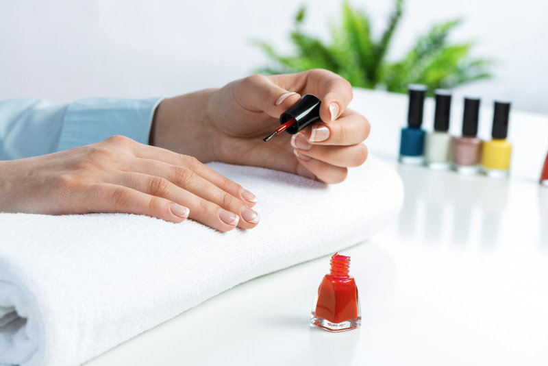  Woman giving herself an elegant manicure at home