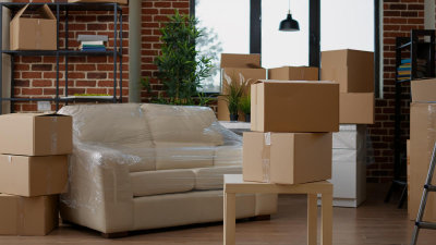 Illustration of a living room interior with no people, showcasing the process of moving in with carton boxes