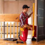 Locksmith Repairing A Door Lock With A Screwdriver.