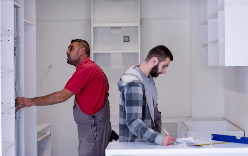 Workers installing a new kitchen